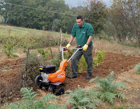Agricoltore al lavoro con la motozappa