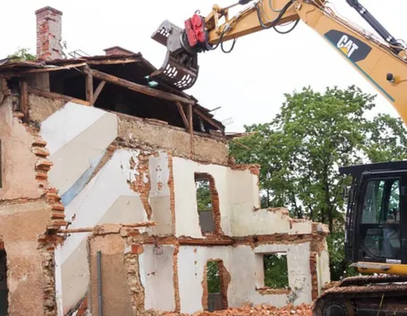 Demolizione di una casa con l'ausilio di mezzi meccanici